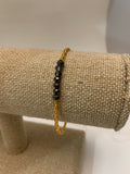 Gold and purple single strand seed bead bracelet