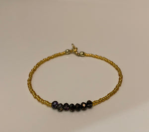 Gold and purple single strand seed bead bracelet